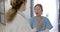 Serious diverse female doctors discussing in hospital corridor, slow motion