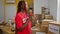 Serious-faced african american woman volunteer, savors espresso coffee indoors at community charity center, embodies the spirit of