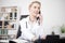 Serious Female Doctor Calling Through Telephone