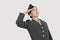 Serious female US military officer saluting over gray background