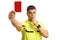 Serious football referee blowing a whistle and showing a red card