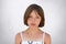 Serious freckled girl with bobbed hair and dark eyes looking directly into camera, isolated over white background. Stylish adorabl