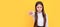 Serious frown school girl point pen putting out hand yellow background, back to school. Banner of school girl student