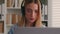 Serious frowning business woman girl businesswoman remote worker distant manager in headphones communicating by video