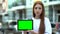 Serious girl holding green screen tablet, online courses, free trial lesson
