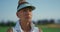 Serious golfer face look away at green field. Focused woman stand on golf course