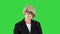 Serious grandmother with wrinkles and short gray hair making a strict look to camera on a Green Screen, Chroma Key.
