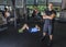 Serious group and motivated diverse people age training inside a gym while a personal trainer loooking at the camera. men and