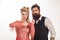 Serious hipster man with beard and woman with scissors. Barber. Beautiful woman cut beard. Couple in barbershop on