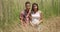 Serious Hispanic couple standing in shrubs