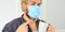 Serious about hygiene. Guy in mask drink tea coffee using straw. Cover mouth and nose with mask and make sure no gaps