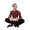 Serious intent teen guy seated on the floor playing video games isolated over white background. Boy stand all ears holding