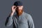 Serious Irish guy adjusting cap. Portrait of bearded guy. Unshaven guy with beard studio