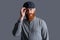 Serious Irish man adjusting cap studio. Portrait of bearded man. Unshaven man with red beard