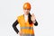 Serious-looking disappointed asian female architect, construction manager at working area wearing safety helmet, showing