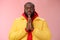 Serious-looking faithful young determined african-american praying guy in yellow coat press palms together pray close