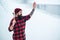 Serious lumberjack on winter day outdoors. Lumberjack lifestyle. Handsome man working in forest