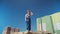 Serious Male Builder in Work Uniform and Hardhat against the Background of Buildings Under Construction. Slow motion.