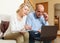 Serious man adn woman reading finance documents together