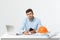 Serious man businessman or engineer sitting in construction site. Courageous middle aged man sit with sad,serious and