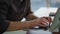 Serious man fingers texting keyboard office closeup. Freelancer working laptop