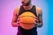 Serious man hold basketball ball in hands