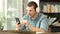 Serious man listening to music on phone in a bar