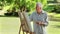 Serious mature man painting on a canvas