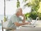 Serious Mature Man Using Laptop Outdoors