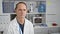 Serious middle-aged male scientist concentrating on his work, sitting in a quiet lab amidst medical research