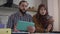 Serious Middle Eastern couple working together in home office indoors. Focused bearded man and concentrated woman in