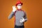 Serious mime in red hat and vest on orange background