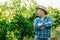 serious modern and young farmer with hat, winery and winemaker