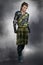 Serious and moody handsome man wearing traditional Scottish battle dress in Highlander style