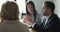 Serious motivated business man talking to team on office meeting