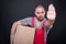 Serious mover man holding box showing stop gesture