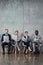 Serious multiethnic businesspeople sitting on chairs and reading newspapers in