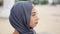 Serious muslim woman in hijab starts to smile