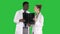 Serious nice woman doctor and afro american doctor study brain x ray on a Green Screen, Chroma Key.