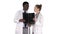 Serious nice woman doctor and afro american doctor study brain x ray on white background.