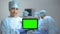 Serious nurse holding tablet PC with green screen during operation, death rate