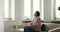 Serious older woman staring out window sit on sofa indoors