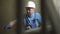 Serious professional worker checking equipment at factory. Portrait of concentrated confident Caucasian man in blue