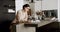 Serious relaxed woman reading book at modern home in cozy kitchen interior.