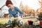 Serious schooler using small shovel while gardening