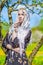 Serious Sensual blond Woman in Kerchief Standing In Spring Fores