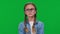 Serious smart girl adjusting eyeglasses on nose looking at camera on green screen. Front view portrait of confident