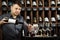 Serious sommelier pouring red wine in decanter