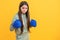 serious teen boxing girl on background. photo of teen boxing girl wearing gloves.