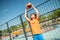 Serious teenage boy doing basketball workout outdoors